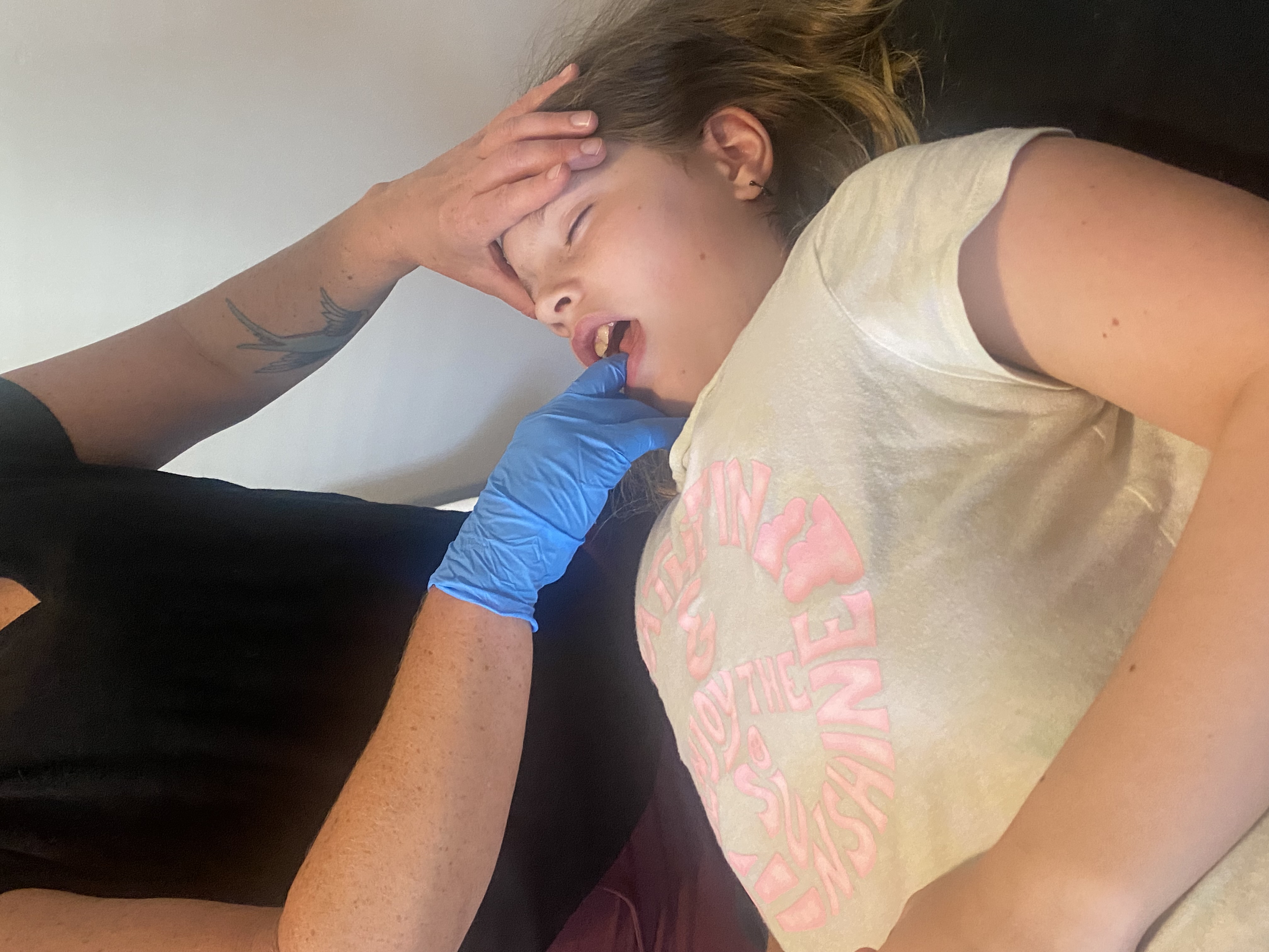 Christine demonstrating careful intraoral treatment with a child