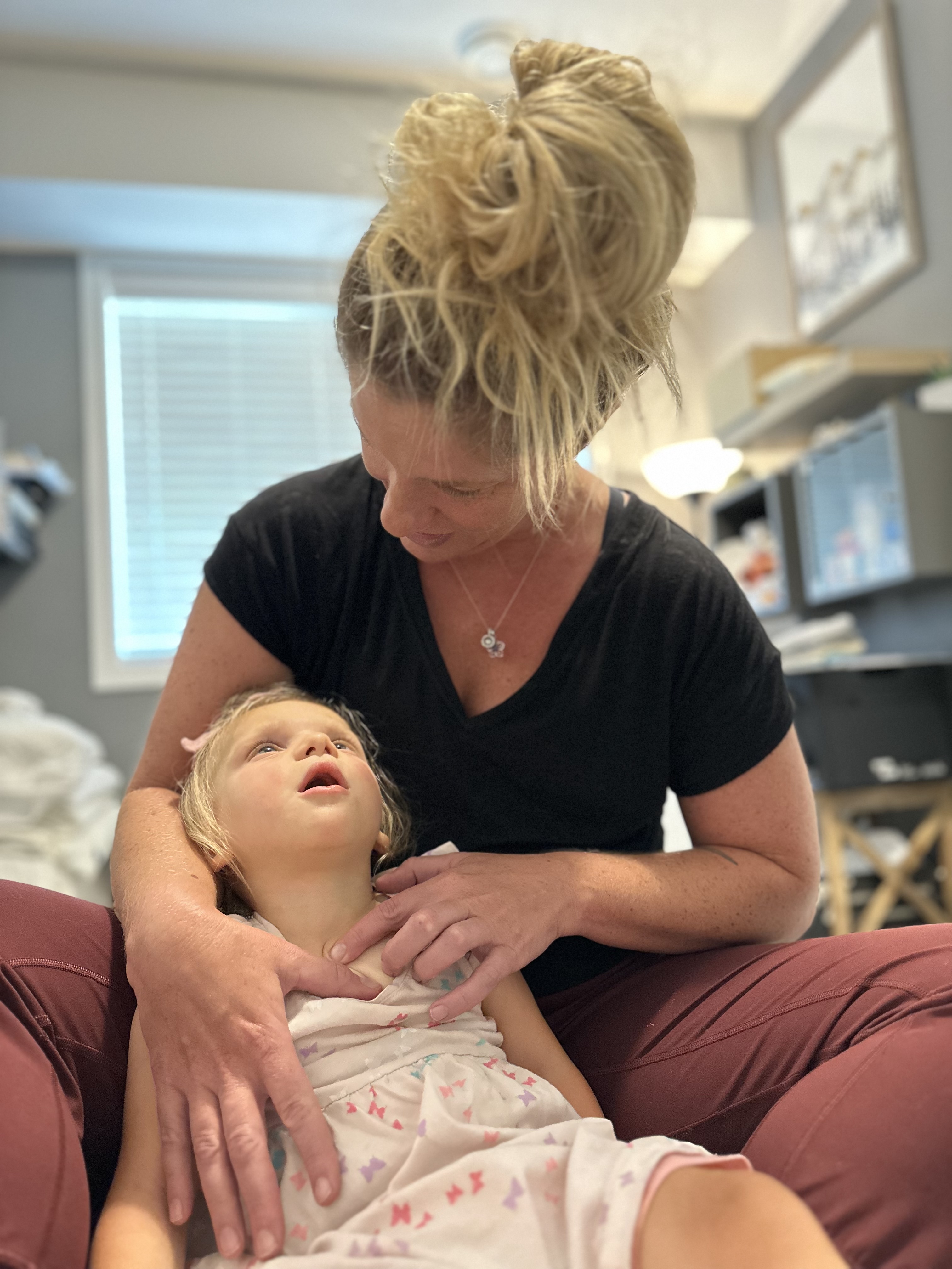 Christine providing gentle, supported care for a young child